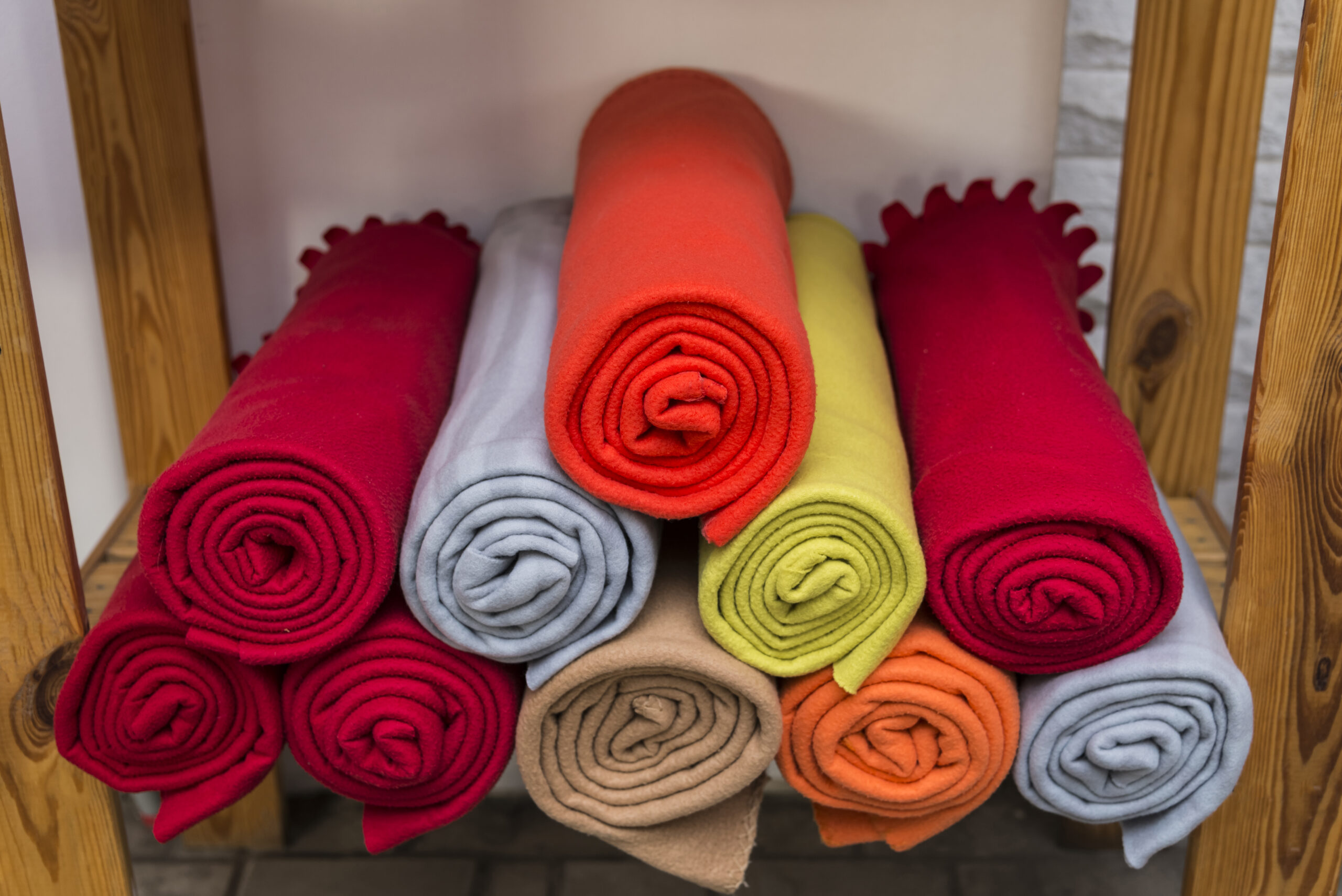 Several colorful plaids on the shelf